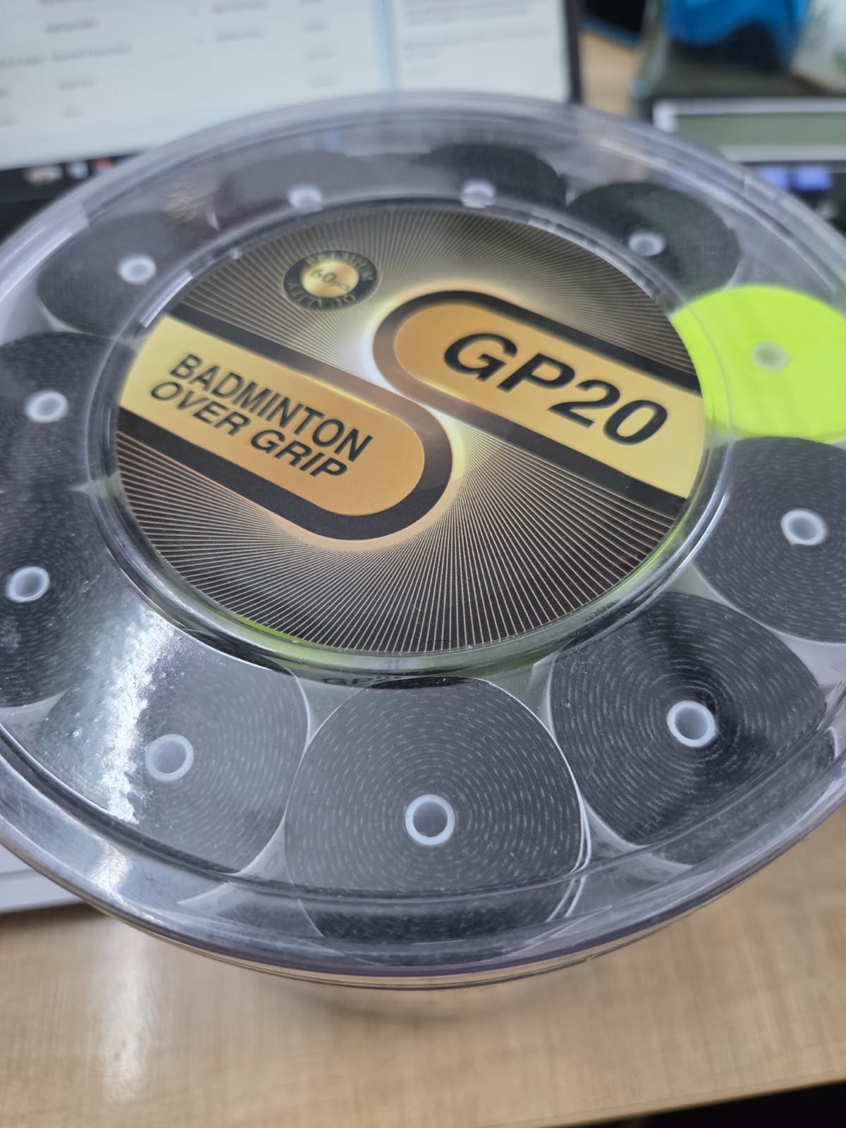 GP20 Badminton Over Grip - Top view showing multiple color rolls in container